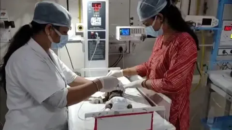 Infant Interred Living in India Struggles for Survival